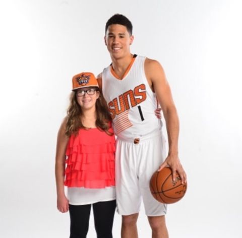 Devin Booker poses a picture with his sister Mya Powell.